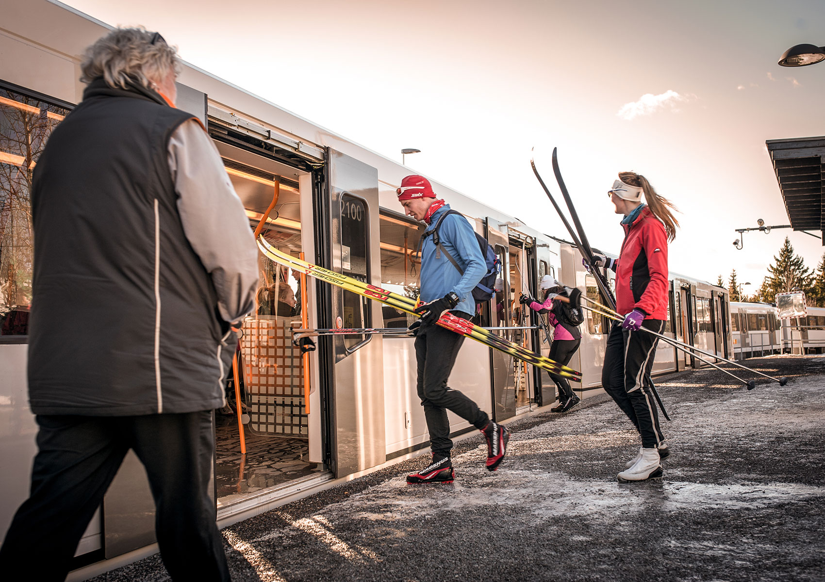 Cross country skiers entering train in Oslo