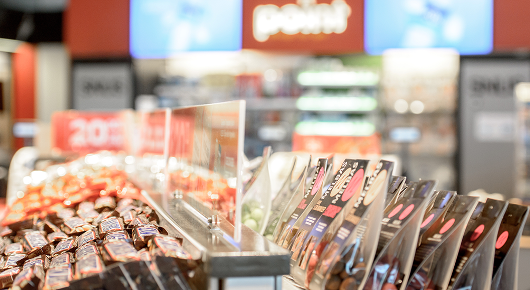 Confectionery display with assorted candies and chocolate bars in a convenience store