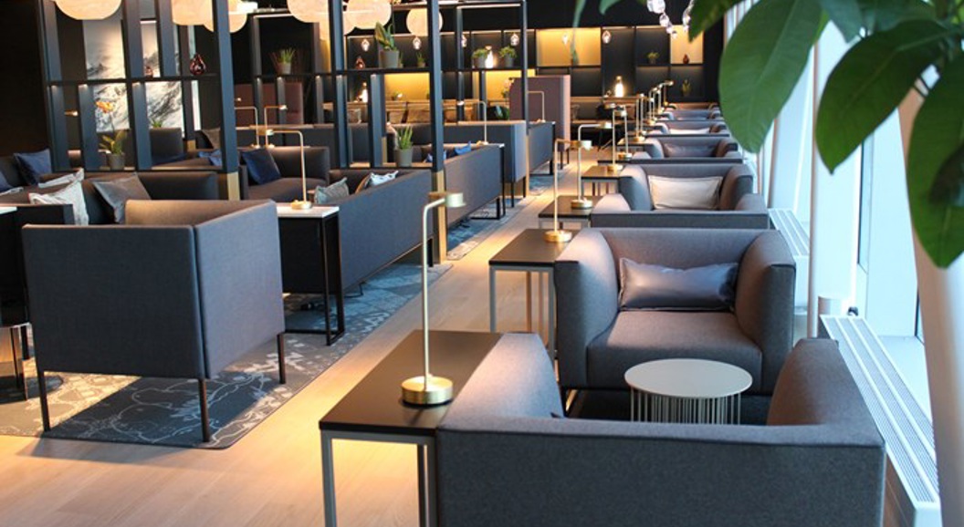 Modern airport lounge with elegant seating, ambient lighting, and contemporary decor, creating a comfortable and stylish environment for travelers