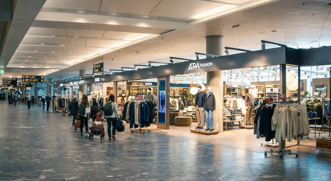 Display of Eton shirts, ties, and bags in a stylish retail store setting, showcasing neatly organized clothing and accessories on wooden shelves
