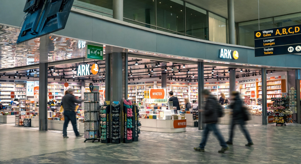 Woman looking at children's books in a bookstore. Handpicking a book from the shelf in the 9-12 age group section.