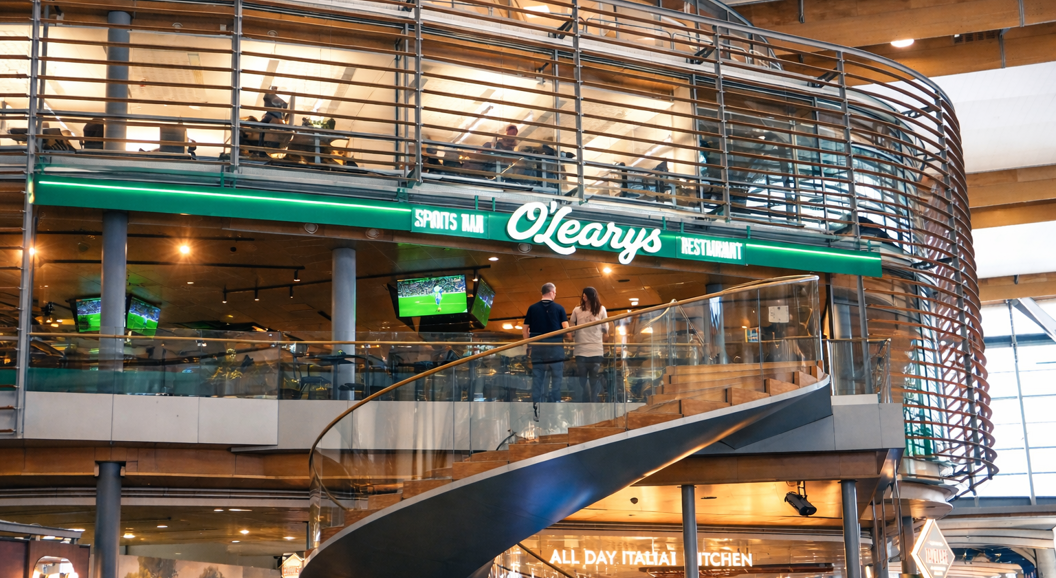 Three gourmet burgers with diverse toppings, served on a rustic black table, highlighting juicy beef patties, fresh lettuce, and melted cheese