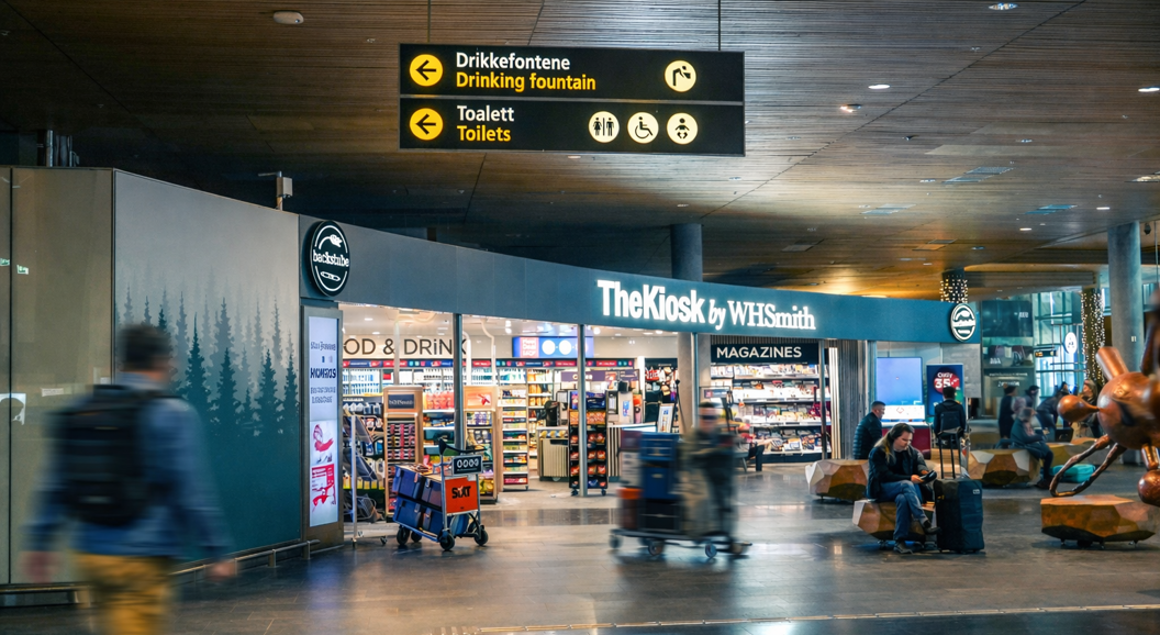 The Kiosk by WHSmith, displaying a variety of snacks, beverages, and essentials in a modern retail setting, with clear signage and accessible self-service options